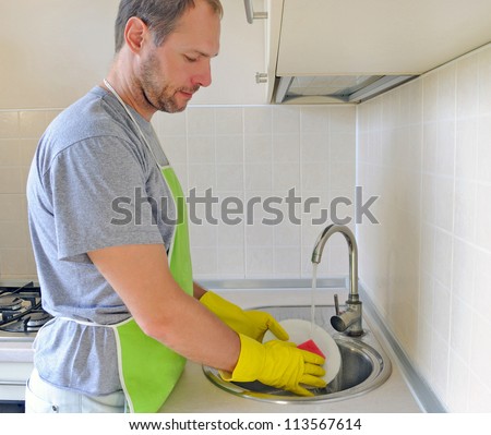 Man washing dish in the kitchen
