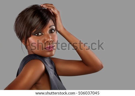 beautiful young african woman with long hair on studio background