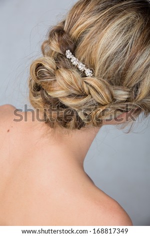 Bridal hairstyle with vintage style hair accessories. Blond Bride. View from the back