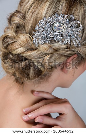 Bridal hairstyle with vintage style hair accessories. Blond Bride. View from the back