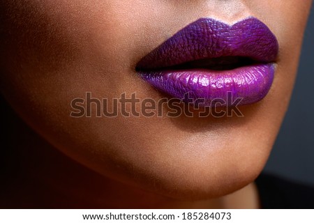 closeup of womanÃ?Â¢??s sexy lips with purple ombre style lipstick on tanned skin