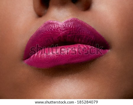 closeup of woman sexy lips with pink lipstick on tanned skin