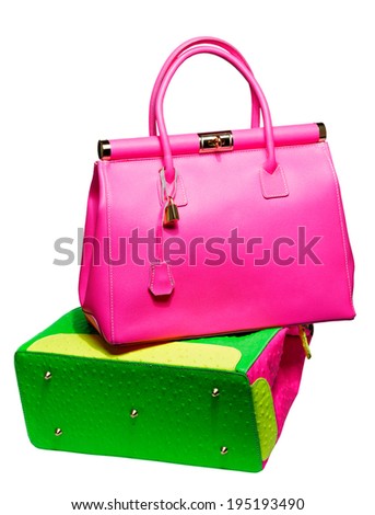 Two bright neon pink, blue and green bags with gold lock and ostrich texture leather isolated on white background