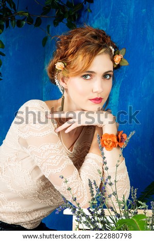 portrait of a beautiful woman with red hair in braided hairstyle and flowers in her hair. wearing leather orange bracelet grunge painted background