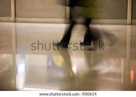 a shot of people\'s feet as they walk through an airport