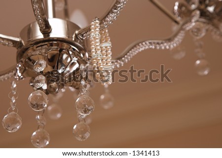 Pearl bracelet hanging on a crystal chandelier