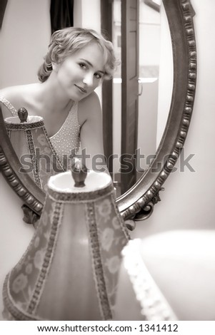 Reflection of a young woman in wedding dress with sepia finish