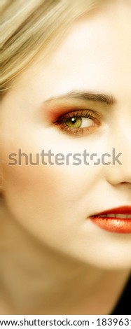 Woman with green eyes and striking bright make-up