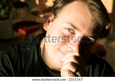 Portrait of a man with blue eyes sitting in natural afternoon light