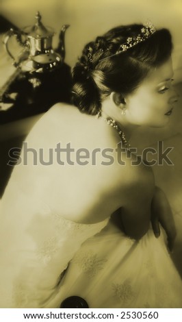 young bride in vintage lace dress with classic hair style in soft sepia monotone finish