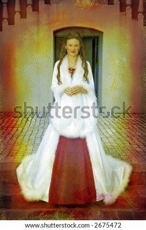 beautiful bride with long brown hair in a long silk white coat with wide sleeves and feather trimming and contrasting red dress