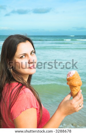 Beautiful woman with long brown hair and smile, caramel ice-cream. No sharpening