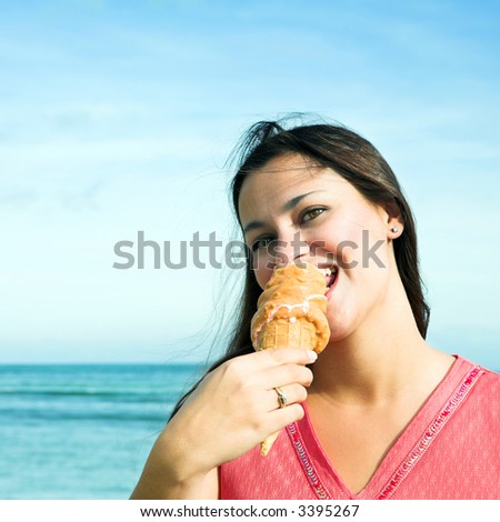 Beautiful woman with long brown hair and smile, caramel ice-cream. ISO 100, no sharpening