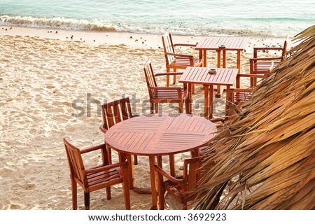 Chairs and tables of outdoor coffee shop on the beach next to sea in Antibes, France