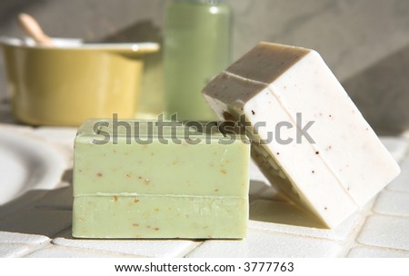 Olive and oatmeal natural organic soaps shot in natural light on bathroom counter