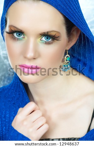 stock photo Blond woman with highfashion makeup in blue metallic top