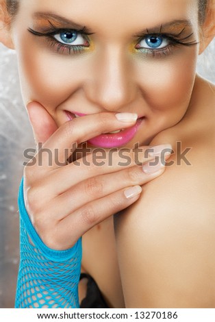 stock photo Beautiful tanned girl with fashion makeup and blue net glove