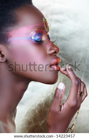 stock photo Beautiful African woman with metallic bronzed tribal makeup 