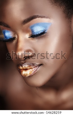 stock photo : African woman with gold and blue metallic make-up and full 