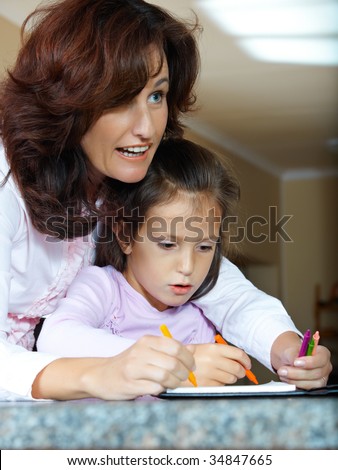 mother helping her daughter with home work