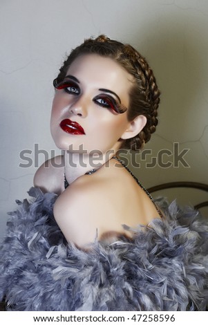 blond woman in feather boa with long fake lashes from 16 Bit RAW