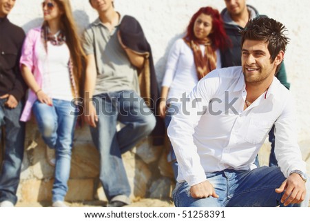 stock photo group of teenagers standing against the wall with their leader