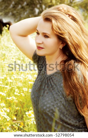 stock photo pretty middle aged casual woman with natural color long red hair in the green field 52798054