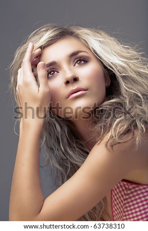 beautiful blond young woman with curly hair and natural make-up