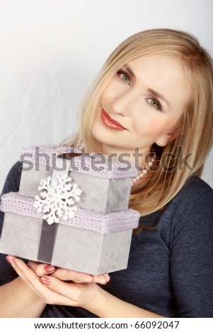 happy beautiful woman with elegant grey gift velvet boxes and silver ribbon