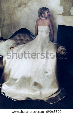stock photo beautiful blond bride in long wedding dress resting on grunge 