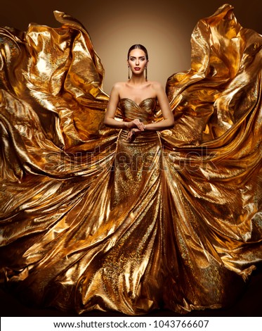 Gold Woman Flying Dress, Fashion Model in Waving Golden Gown, Fluttering Fabric Fly like Wings, Art Beauty Portrait