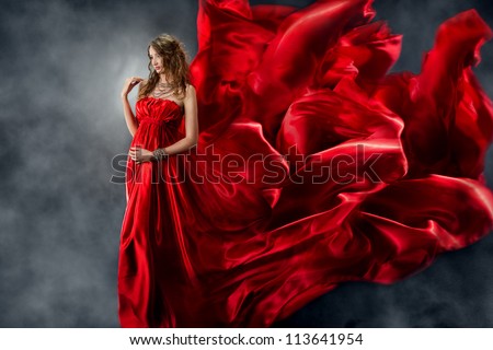 Woman in red dress waving on wind. Looking down.