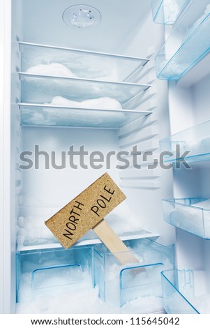 Fridge with frost and North Pole sign. Global warming