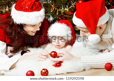 Christmas family of four persons in red hats giving gifts