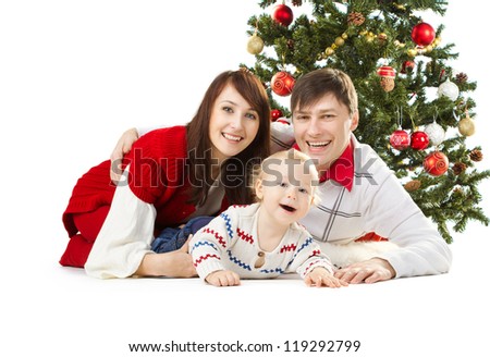 Christmas family of three persons and fir tree, smiling happy parents and child