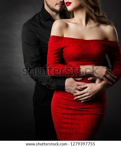 Couple Fashion Beauty, Young Woman in Sexy Red Dress and Embracing Man in Love