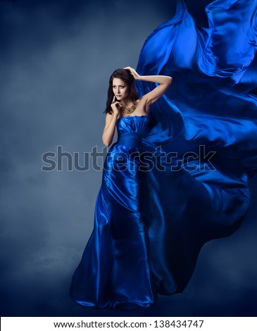 Woman in blue dress  with flying silk fabric
