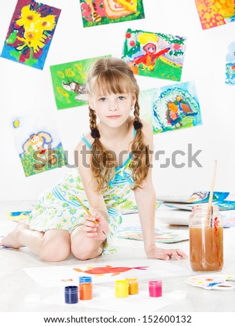 child girl drawing with color paint brush. Children art and creativity concept.