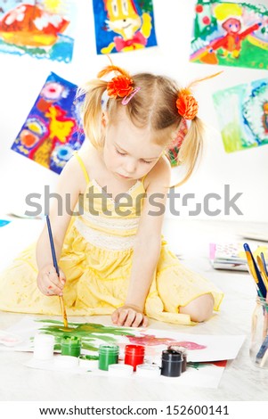 child girl drawing with brush. art education and creativity concept.