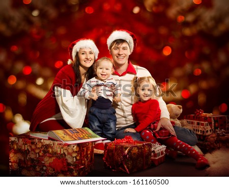 Christmas family of four persons happy smiling over red background