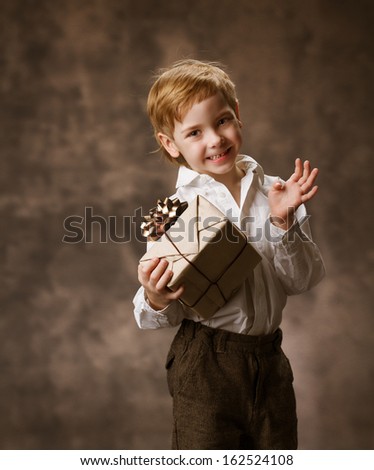 Child holding present gift box, brown vintage style birthday.