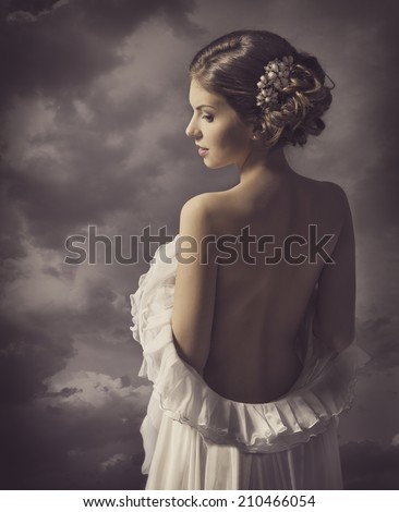 Woman retro fashion dress elegant vintage style girl on gray background naked back Woman retro fashion dress elegant vintage style girl on gray background naked back