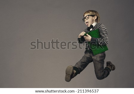 child running back to school, funny kid portrait, jumping smart schoolboy with glasses and book