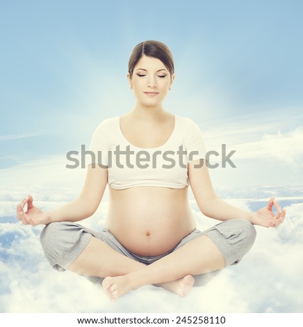 Pregnant Woman Exercise Yoga. Meditate Sitting in Lotus Position over Sky Background