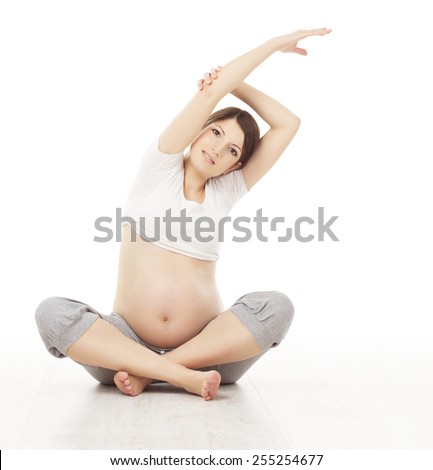 Pregnant Woman Yoga Exercising Pregnancy Prenatal Health Care and Exercise Gymnastics Mother Sitting in Lotus Position Crossed Legs over White Background Pregnant Woman Yoga Exercising Pregnancy Prenatal Health Care and Exercise Gymnastics Mother Sitting in Lotus Position Crossed Legs over White Background