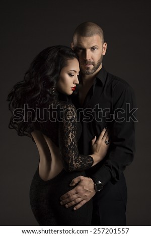 Couple Man and Woman in Love, Fashion Beauty Portrait of Models Embracing over Black Background
