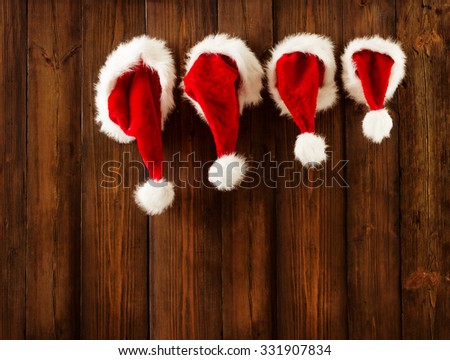 Christmas Family Santa Claus Hats Hanging on Wood Wall, Xmas Kid Hat Hang on Decorated Background