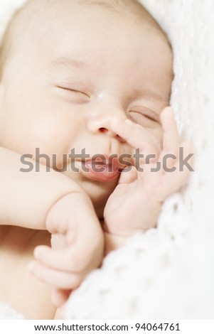 closeup of sleeping newborn baby  over white blanket
