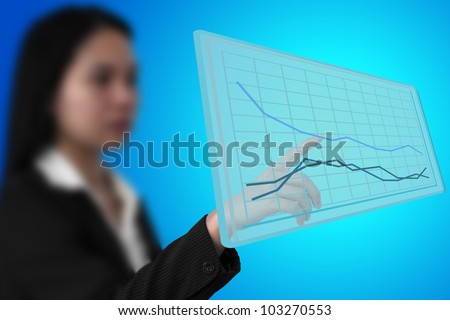 business woman touch up trend graph on virtual interface (Selective Focus at finger)
