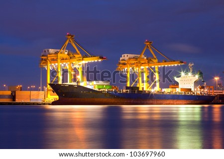 Container Cargo freight ship with working crane bridge in shipyard at dusk for Logistic Import Export background Container Cargo freight ship with working crane bridge in shipyard at dusk for Logistic Import Export background